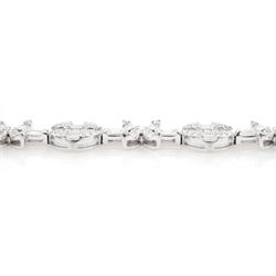 18ct white gold diamond bracelet, eight circular, pave set round brilliant cut and baguette cut diamond clusters, spaced by a single baguette cut diamond and a diamond flower head design cluster, stamped 750, total diamond weight approx 3.70 carat