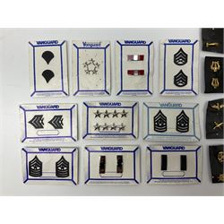 Fifty US rank badges and trade badges; WW2 and Vietnam period; predominantly on sale cards
