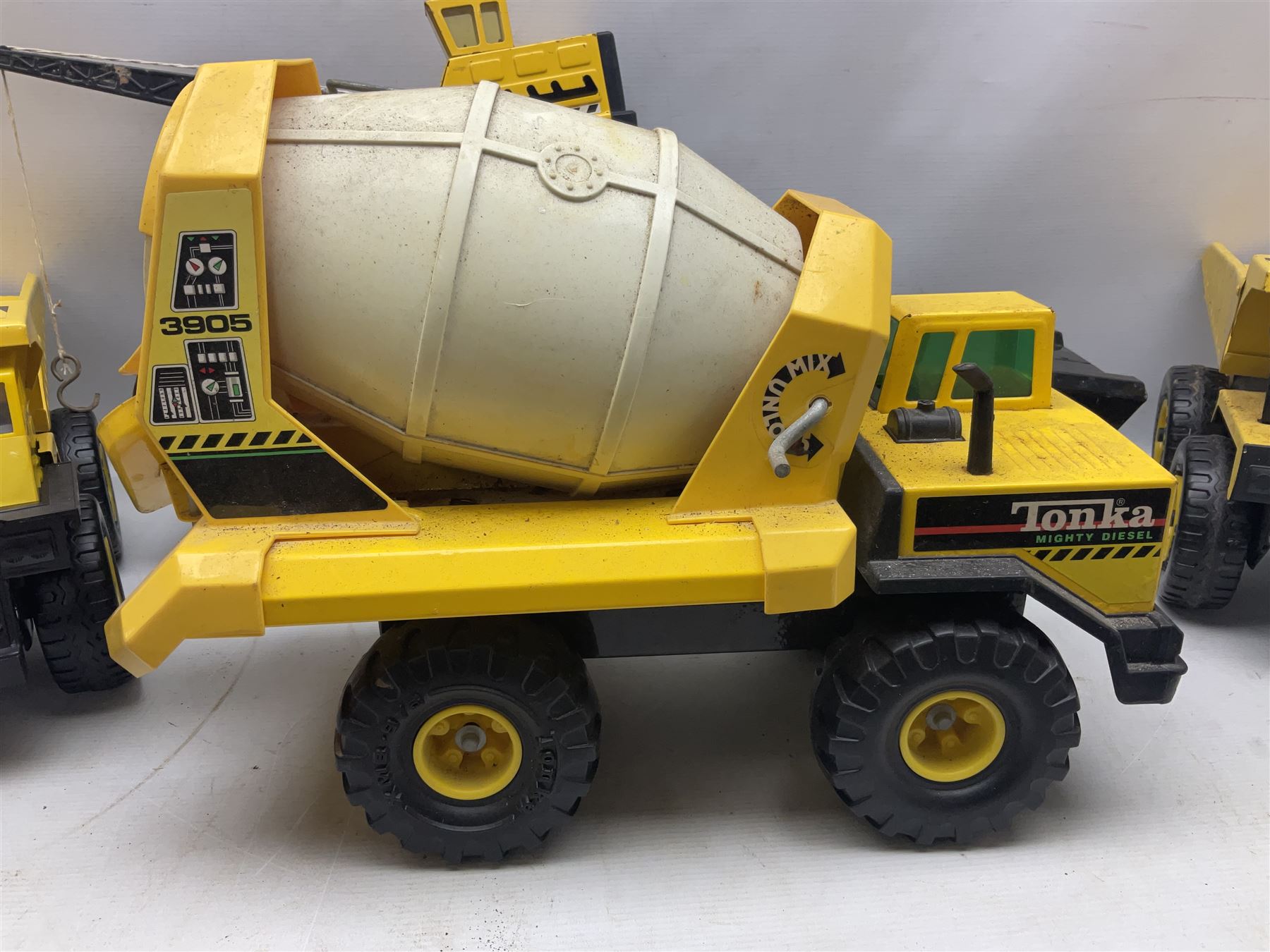Tonka - five large scale steel pressed vehicles comprising Cement Mixer, Car Transporter, Mobile Crane and two Dumper Trucks (5)