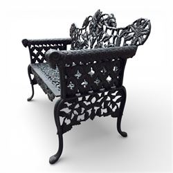 Coalbrookdale style - cast iron garden bench, with pierced foliate back, rams head arms, raised on cabriole legs, finished in green paint.