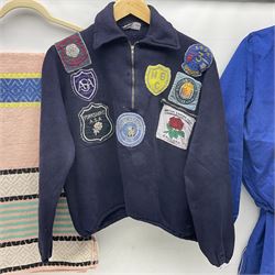 On the direct instructions of Anita Porter nee Lonsbrough Great British Olympic and Commonwealth Games gold medal winning swimmer - collection of early and international memorabilia comprising original Huddersfield Bath Club track suit top bearing eight stitched on cloth badges including British Empire & Commonwealth Games 1958 England Team, YSASA, North Eastern Counties ASA, ESSA Division 3,  English Schools Swimming Association winner etc
The swimming costume Anita wore at the 1958 Commonwealth Games in Cardiff, her first major championships, where she won two gold medals. The grey elastic on the sides, in those days, she would use to make it tighter and more streamlined.
Blue track suit from the 1960 Olympics which she wore on the podium receiving the gold medal.
1960 pool side towelling robe used at the Rome Olympics (interesting to note her name is spelt wrong on the embroidered label).
1962 Commonwealth Games pool side towelling robe used in Perth Australia when winning three Gold medals. 
It was also this year she became BBC Sports Personality of the year, the first female to do so.
Her 'lucky' pool side towel which she took with her to every event she competed in and which can be seen round her neck in many official celebratory photographs. Copies of some of these photographs are included for identification.
In addition there are two souvenir programmes of an evening event to honour Anita at The Theatre Royal Huddersfield and she has kindly signed the front cover on one of these.