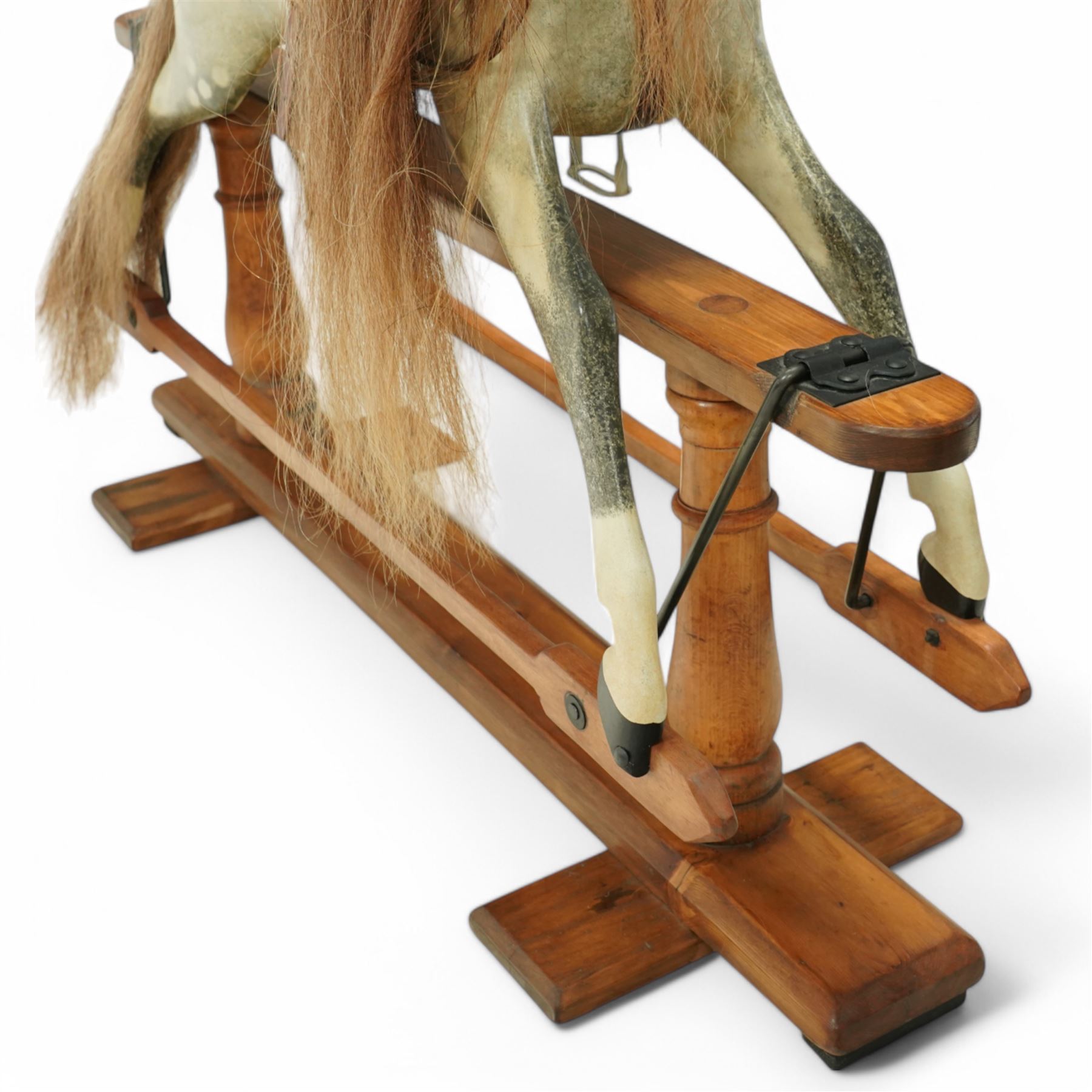Frederick Henry Ayres (F H Ayres, London) - Late Victorian large carved wooden rocking horse, in dapple grey paint finish, decorated with glass eyes, leather reins, stirrup and saddle, indented hooves, on rockers united by chamfered stretchers and boarded base, c.1890