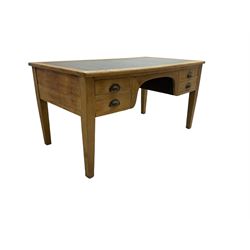 Early to mid-20th century light oak desk, rectangular top with inset writing surface, fitted with four graduating drawers, raised on square tapering supports 