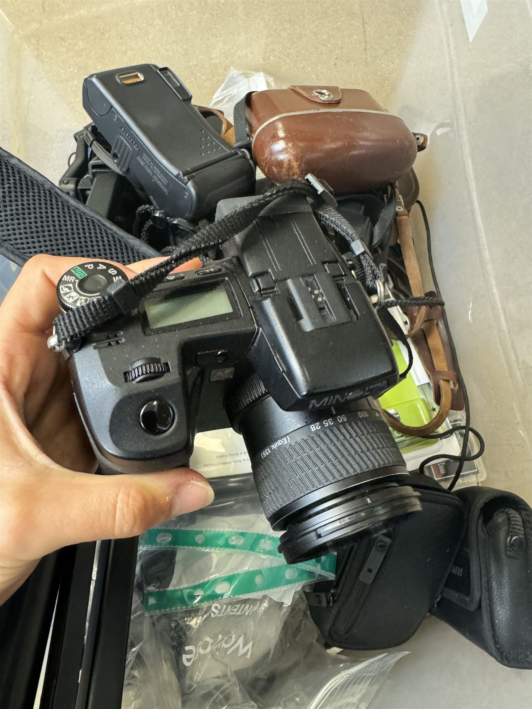 Collection of cameras and camera equipment, including Voigtlander Vitomatic I, Nikon Coolpix P340, Nikon Coolpix S9100, Olympus SP-510UZ, tripod, cases, etc