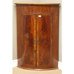  George III mahogany and rosewood banded bow front corner cabinet, figured doors enclosing three shelves, W77cm, H111cm  