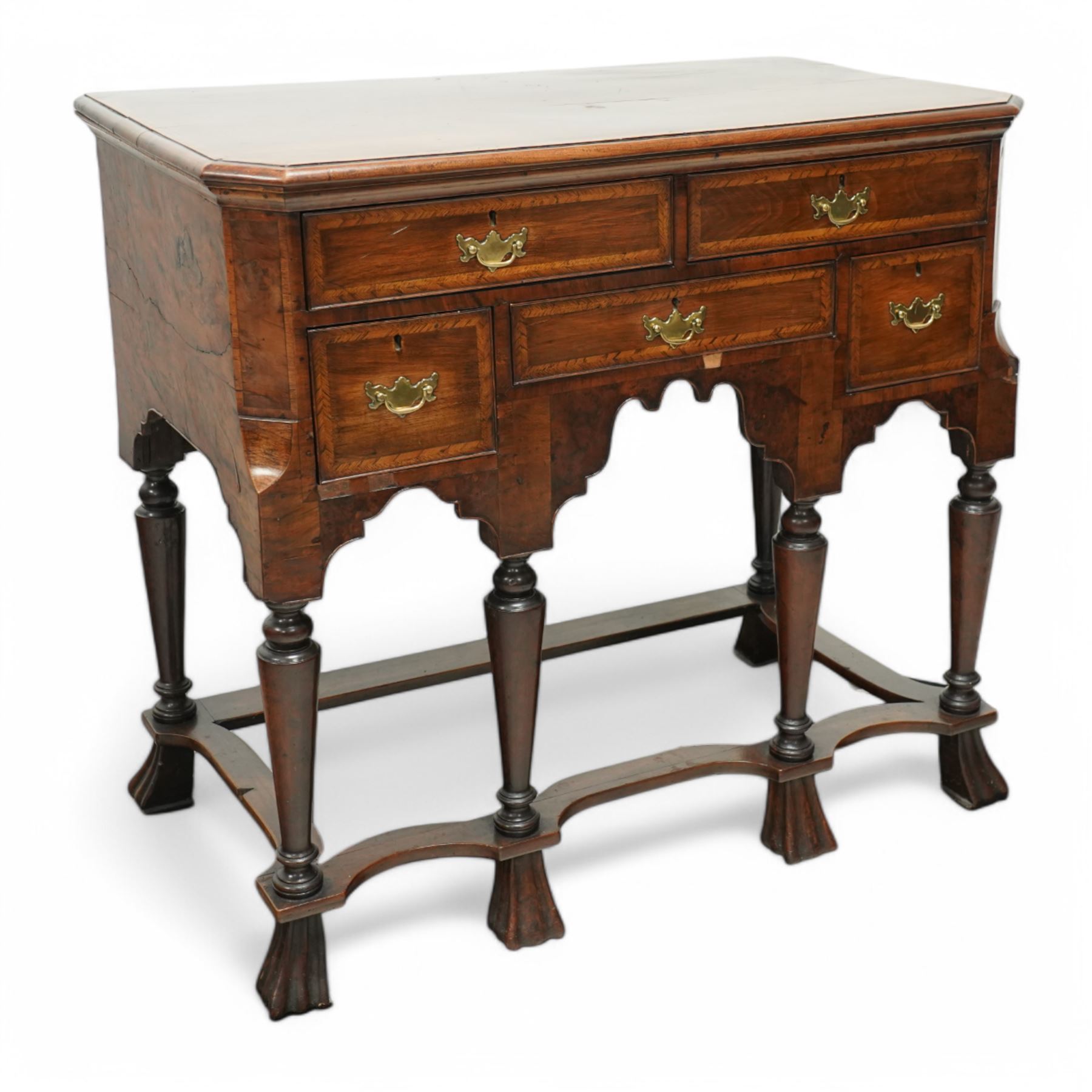 William and Mary design 18th century walnut and yew wood dresser or console table, rectangular canted top with feather banding and moulded edge, over two long and three short cock-beaded drawers, flanked by chamfered uprights above a shaped and cock-beaded apron, raised on six turned and tapering supports united by a shaped box stretcher, on lobed feet 