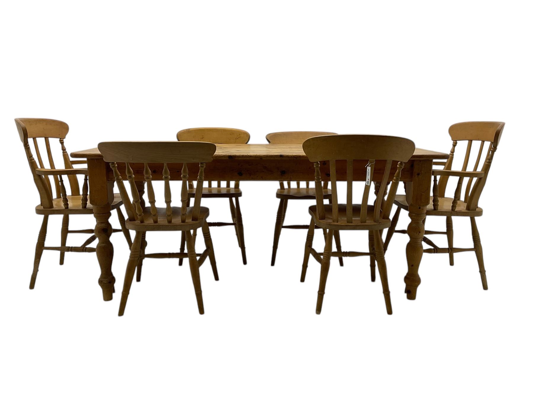 Pine farmhouse dining table, rectangular top with rounded corners, raised on turned supports; together with a set of six (4+2) spindle-back dining chairs