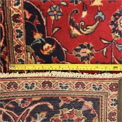 Central Persian Kashan rug, crimson ground with central medallion with  quarter medallions in each corner and decorated with floral sprays and palmettes, dark blue main border with repeating palmette and vine pattern   framed by small guard border with floral meanders 