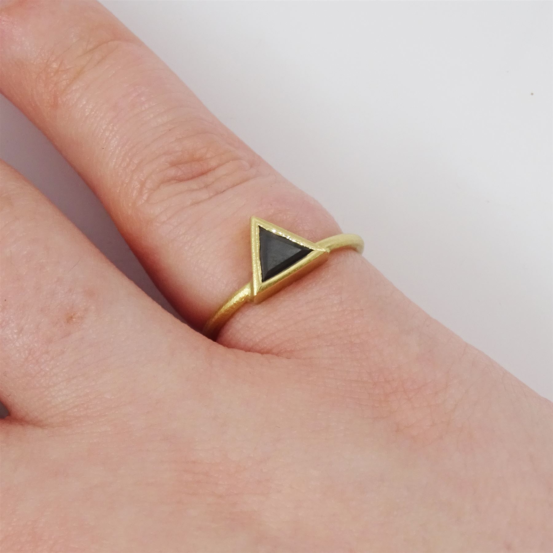 18ct gold black diamond ring, bezel set with a single trilliant cut diamond of approx 0.45 carat, stamped