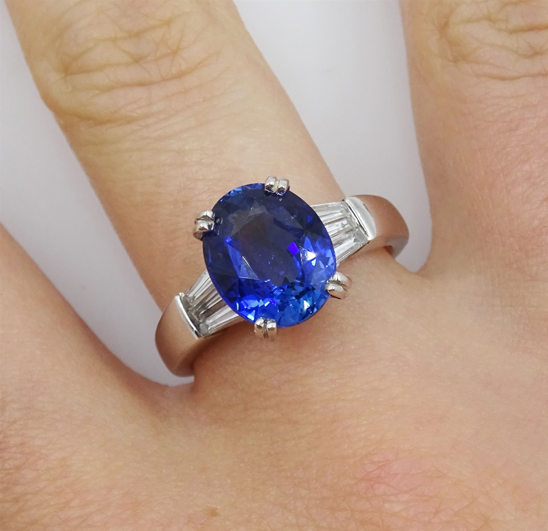 18ct white gold oval sapphire ring, with tapered baguette diamond shoulders, sapphire approx 4.15 carat