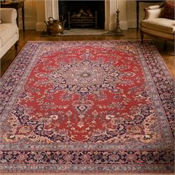 North East Persian Meshed hand-knotted rug, madder red field with central multi-lobbed med...