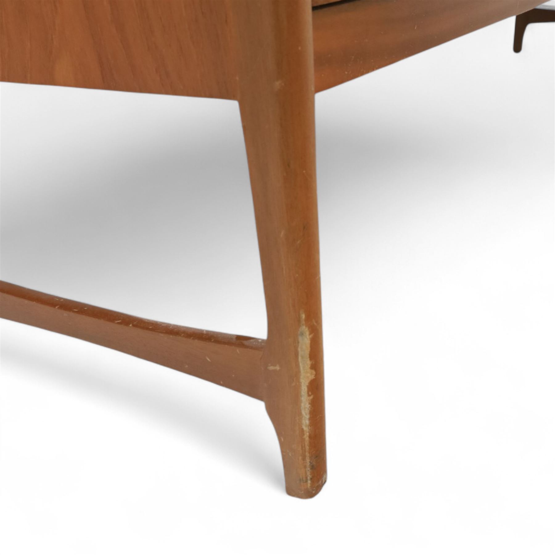 Nathan - mid 20th century teak sideboard, fitted with three drawers with brass ring handles, above a central fall front cabinet, flanked by two cupboard doors, raised on square tapering supports