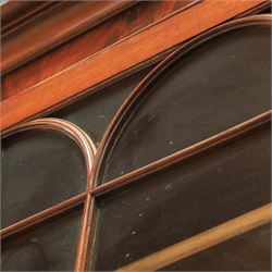 Early 19th century mahogany secretaire-bookcase, projecting cornice above astragal glazed cabinet with adjustable shelved interior, fall front secretaire drawer, fitted interior with pigeonholes and drawers, flame mahogany fronted cabinet with three drawers, on turned supports 