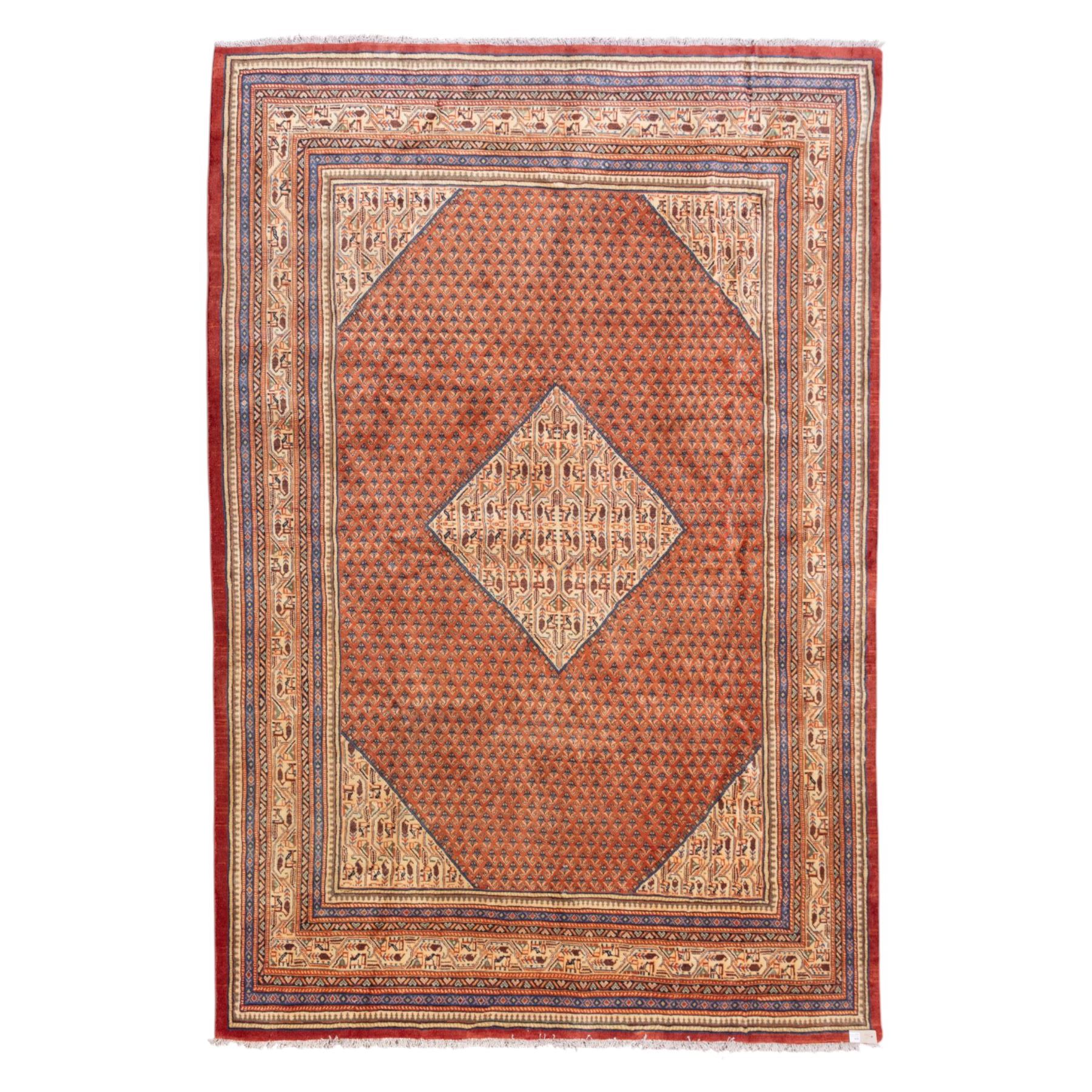 North West Persian Boteh-Mir hand-knotted rug, madder red field decorated with an all-over lattice of small boteh motifs and a central stepped lozenge medallion with repeating stylized boteh and geometric devices, spandrels similarly worked, with multiple narrow borders of floral and geometric bands, in tones of madder red, indigo blue, ivory, and soft green, with cotton fringe ends 