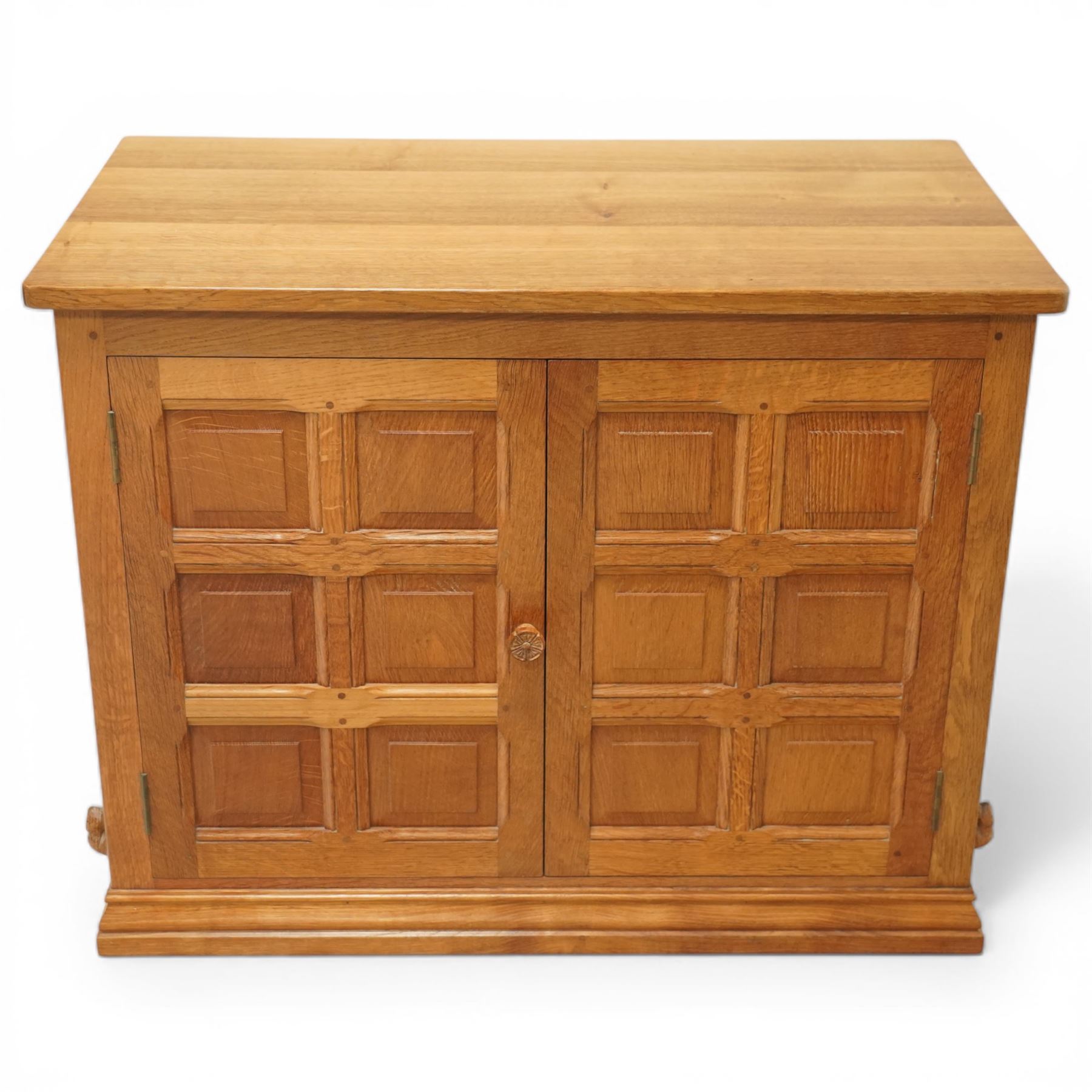  Beaverman - oak media cabinet, rectangular top with interictally carved panels to the side and front doors, twin doors with Yorkshire Rose carved wooden knob, enclosing a staggered shelf arrangement above two drawers, raised on a moulded plinth base, with carved beaver signature, by Colin Almack of Sutton near Thirsk