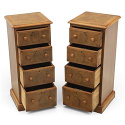 Traditional walnut inlaid pair of tall bedside chests, figured top with inlaid banding, four graduating drawers with wooden turned knobs, raised on a plinth  