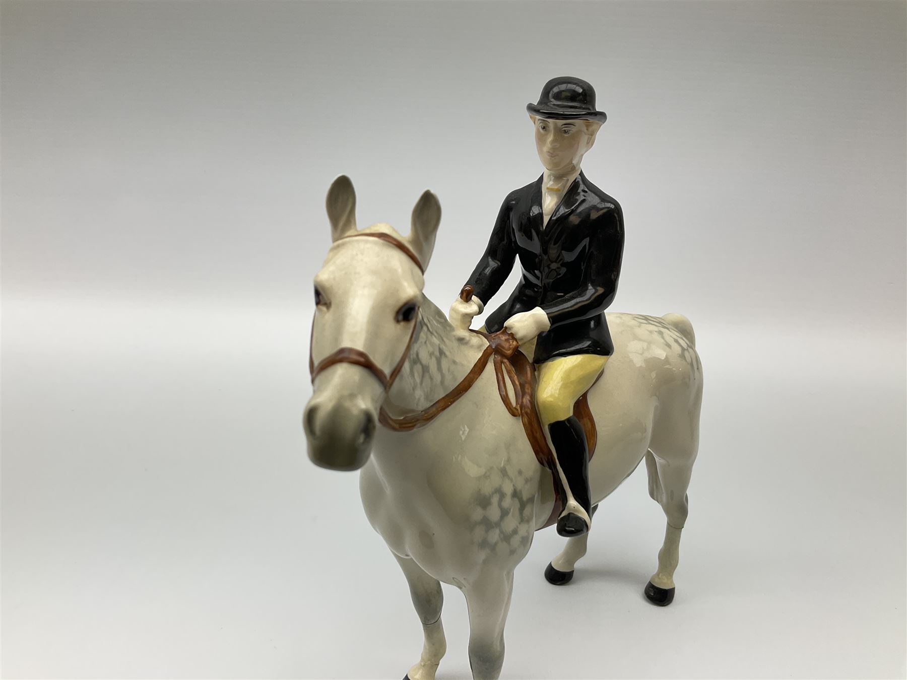 Beswick model of a huntswoman on grey horse model no 1730, and Beswick huntsman on brown horse model no 1501, both with printed mark beneath. 