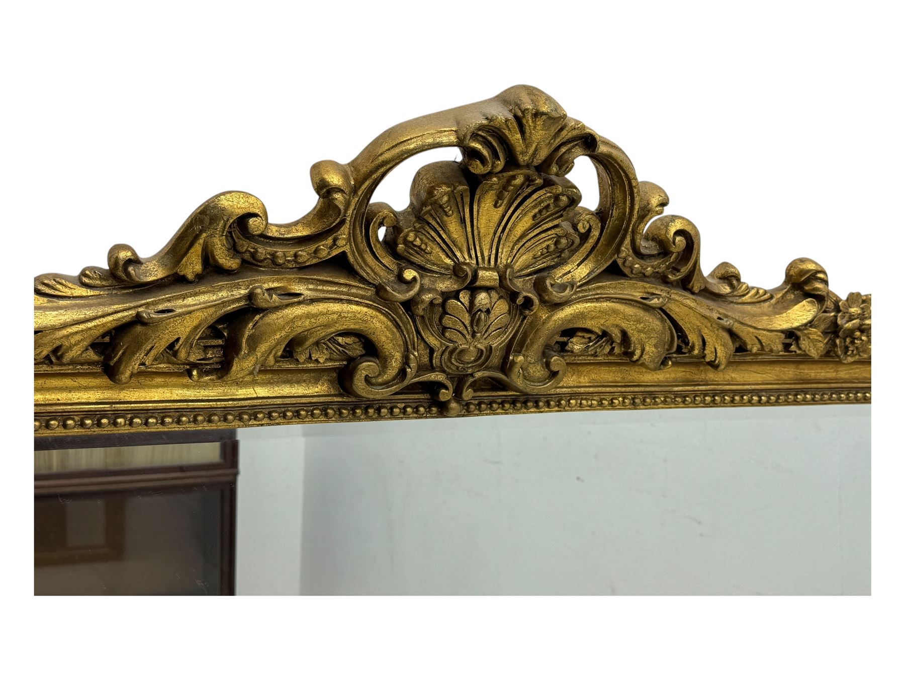 18th century design ornate gilt framed overmantle mirror, bevelled mirror plate within arched frame with pierced pediment featuring foliate and scrollwork designs