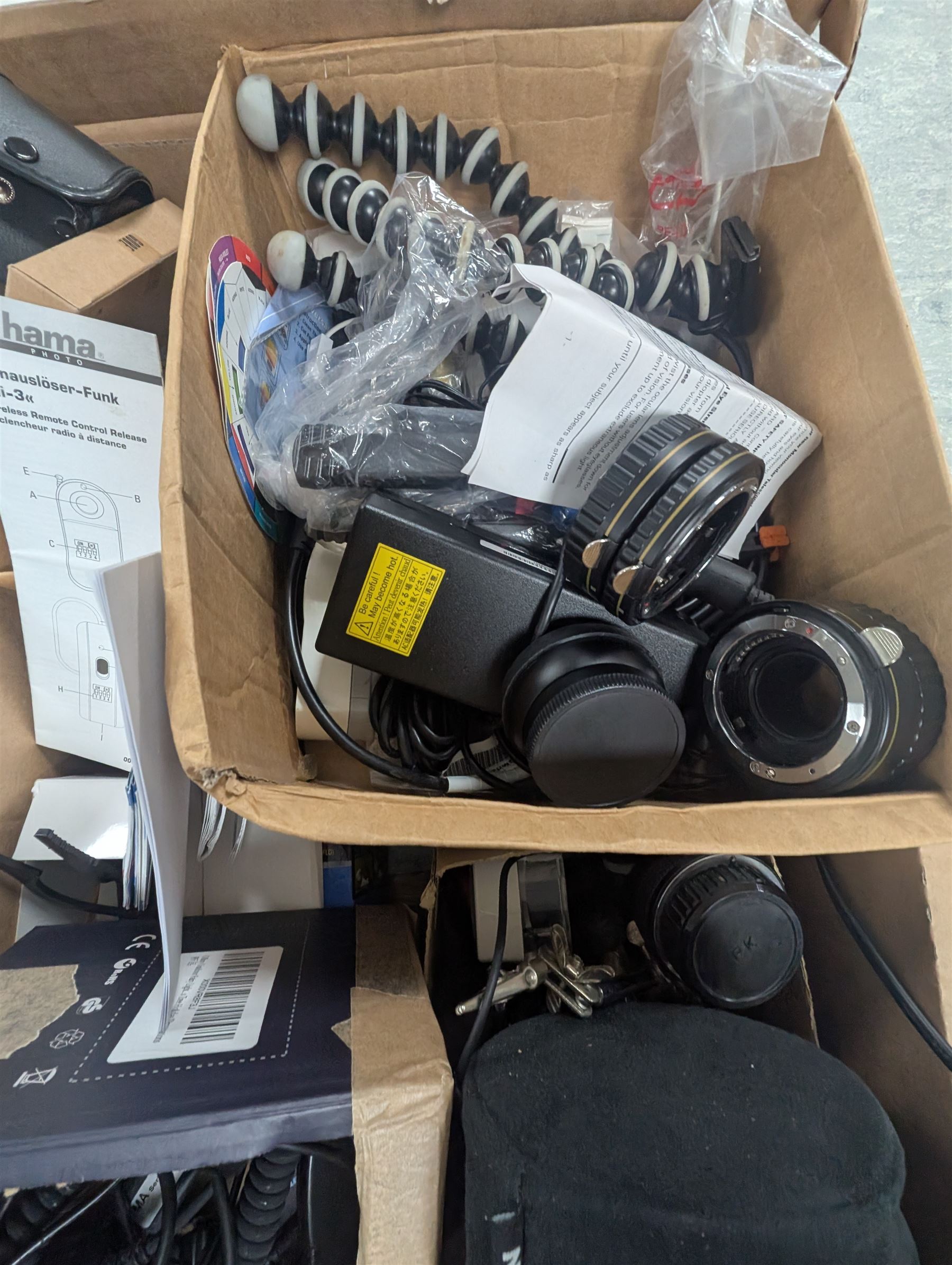 Collection of photography equipment, including flashes, hoods, filters, telephoto lens, bags, etc