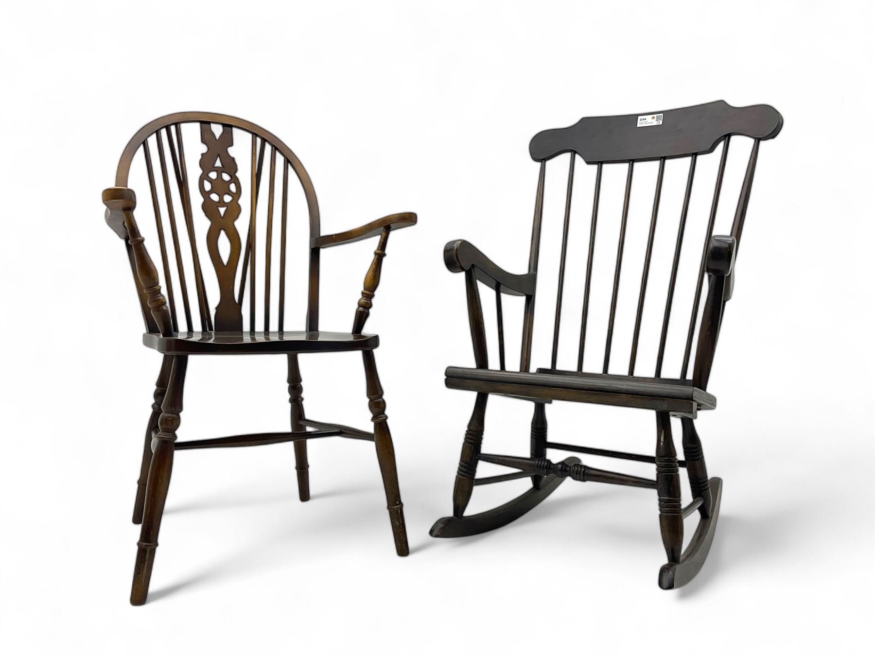 Early 20th century Windsor design rocking chair, shaped cresting rail over a spindle back, curved arms and plain seat, raised on turned supports with curved rockers; mahogany wheelback armchair raised on turned supports with H-stretcher 