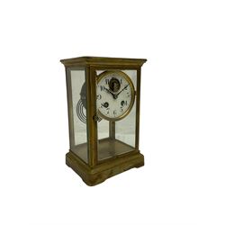 A 20th century French four-glass clock c1920, with four bevelled glass panels and an eight-day striking movement striking the hours and half hours on a coiled gong, enamel dial with visible lever platform escapement, Arabic numerals, minute markers and steel fleur de Lis hands, with an engraved inscription to the front of case dated 1925.  



