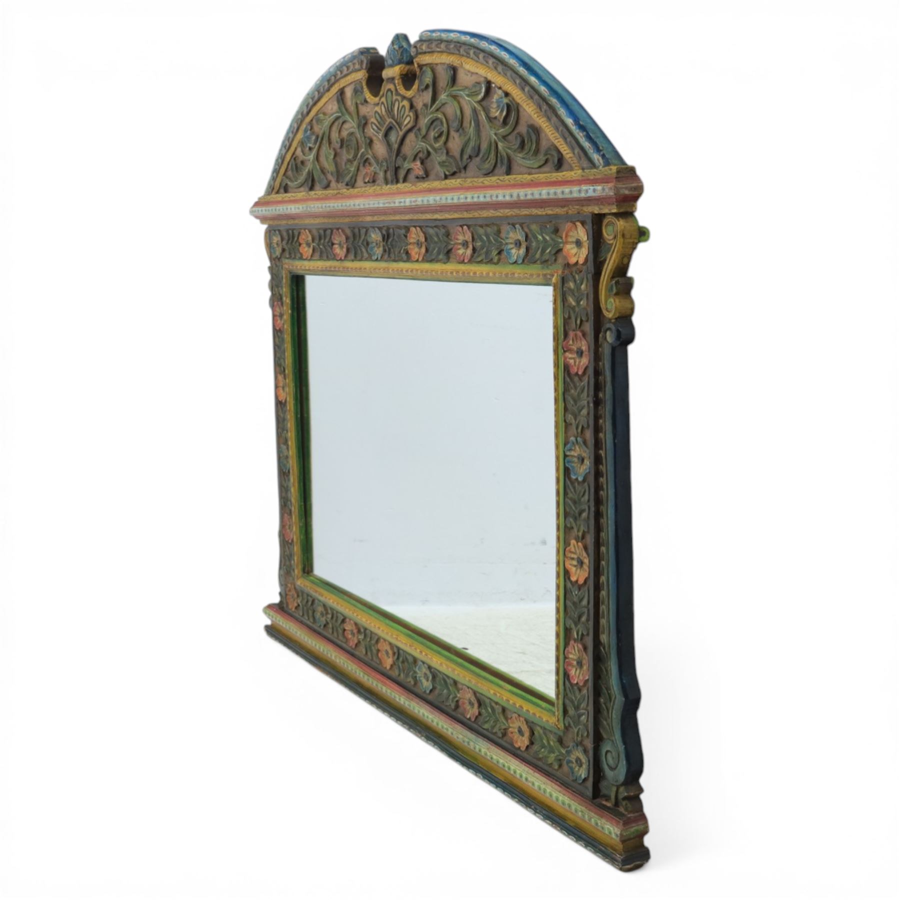 Late 20th century Venetian style polychrome carved wall mirror, arched cresting with central shell motif and scrolling foliate decoration, moulded frame with carved floral borders in relief, enclosing rectangular mirror plate, shaped sides with scroll terminals
