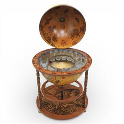 Late 20th century drinks globe, with lift off top with rotating inside with apertures for bottles, raised on brass castors
