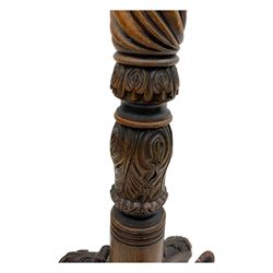 Late 19th century mahogany torchère stand, with circular top above a twisted and foliate carved collumn, on a scroll carved tripod base, on cabriole legs
