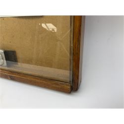 Display of eleven German belt buckles including 'SS', Party Buckle, two Army, Fire Service, two Luftwaffe, NSKK, Hitler Youth and WW1 Army; framed with three cloth badges and an armband