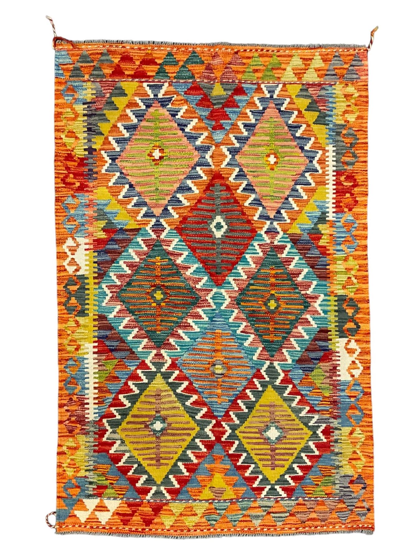 Chobi Kilim rug, multi-coloured ground in oranges, blues and greens, overall geometric design 