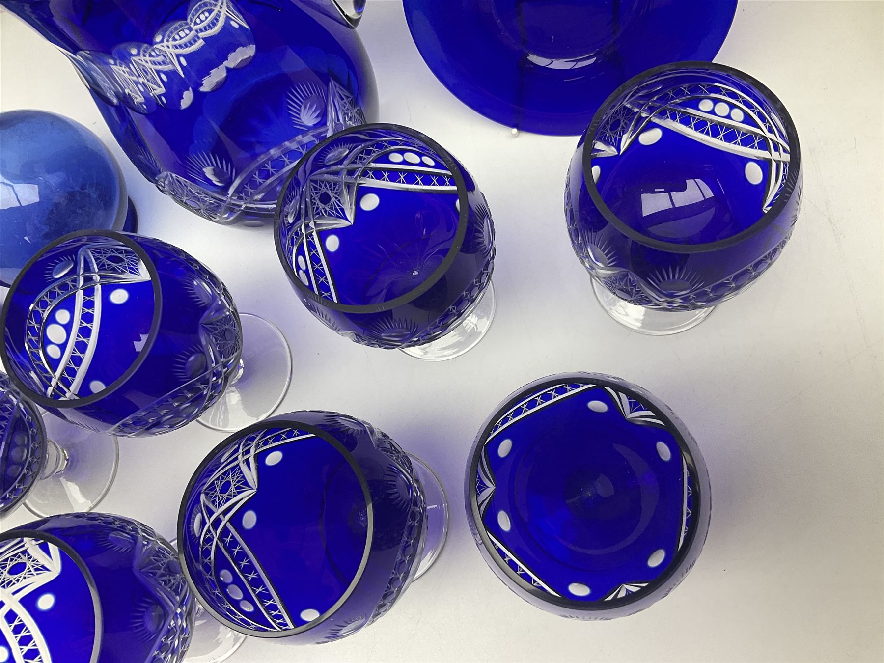 Bristol blue glass jug, together with blue claret jug, saucer, blue cut water jug, and seven matching glasses, water jug H22cm