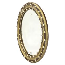 Regency design Irish oval wall mirror, circular frame with ebonized slip and two rows of applied glass ball decoration 
