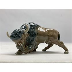 Four Lladro figures, comprising Leopard Butterfly no 11684, Bison Attacking no 5313, Rhino no 5437 and Bear Seated no 1206, all with original boxes, largest example H8cm
