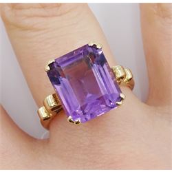 Gold single stone amethyst ring with scroll design shoulders and heart gallery, stamped 9ct