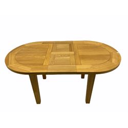 Solid oak oval extending dining table, butterfly leaf extension, four chairs with brown upholstered seats