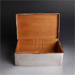 Two silver cigarette boxes, comprising early 20th century plain rectangular example with compartmentalised softwood interior, hallmarked Birmingham 1914, maker's mark indistinct, and an early 20th century example with engine turned decoration and engraved initials to cover, hallmarks worn and indistinct, largest H4.5cm, W21cm