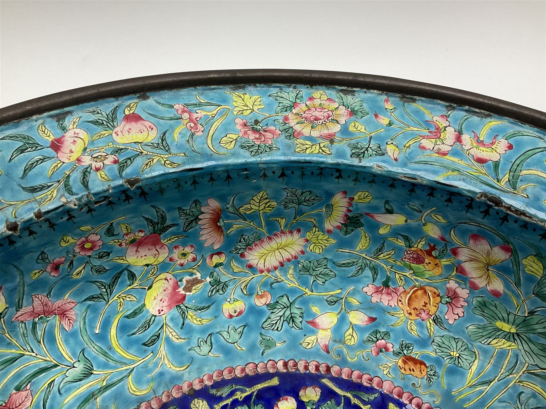 18th/19th century Chinese Canton enamel basin, the circular basin with flat everted rim, decorated with scrolling foliate and fruit decoration on a blue ground, D43cm