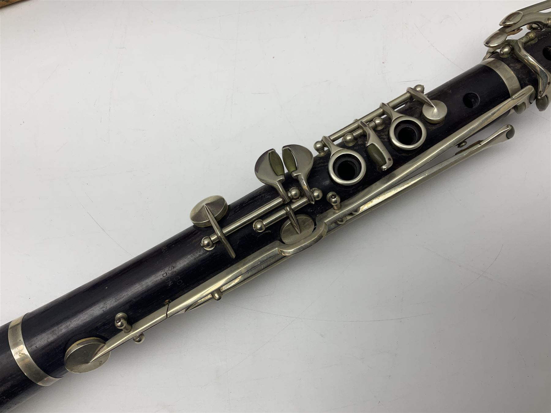 Early 20th century Hawkes and Son simple system hardwood clarinet serial no.1HM257102; cased; and a Swiss Maelzel BS Dulcet metronome of typical pyramid form (2)