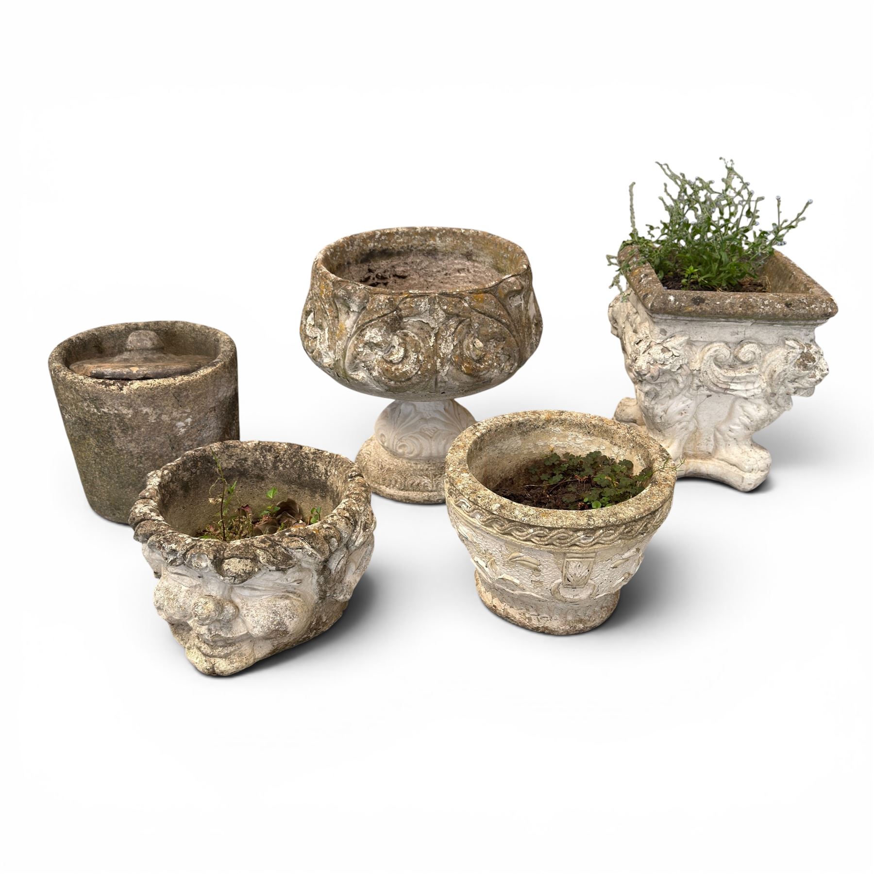 Five composition stone garden planters, comprising various circular and square forms with relief foliate decoration, together with a cylindrical lidded garden pot.