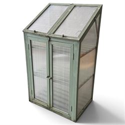 Three green-painted timber cold-frame greenhouses or growhouses, each with twin hinged sloping polycarbonate lids above a pair of panelled doors enclosing slatted shelves