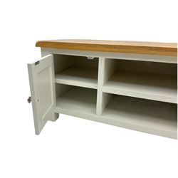 Oak and white painted television stand, fitted with two cupboards and centre shelves
