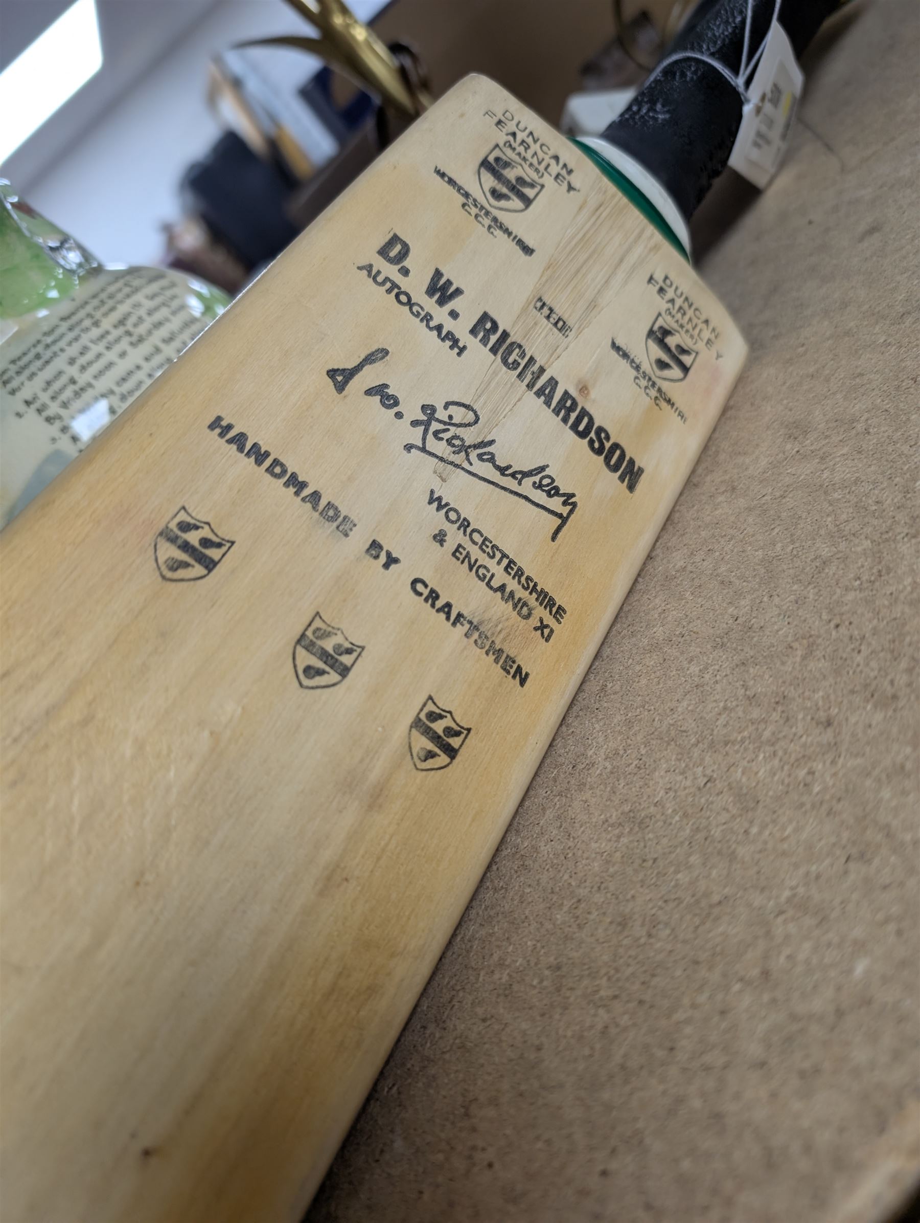 Two signed cricket bats, with signatures including Colin Cowdrey