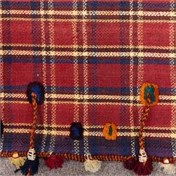 South West Persian Jajim kilim flatweave runner, composed of joined narrow woven bands,  field decorated with checked and striped motifs in shades of madder red, indigo, ivory ochre, and green, sides applied knotted wool tufts and braided elements with tasselled edges, (due to the large size, the runner is illustrated in two sections) 