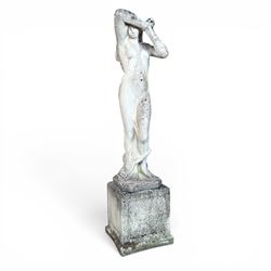 Weathered cast stone garden statue of a 'Shy Maiden', raised on square plinth base
