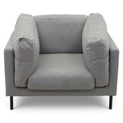 Modern snuggler armchair, upholstered in grey fabric, box-shaped frame with loose back and side cushions, raised on slender black metal legs