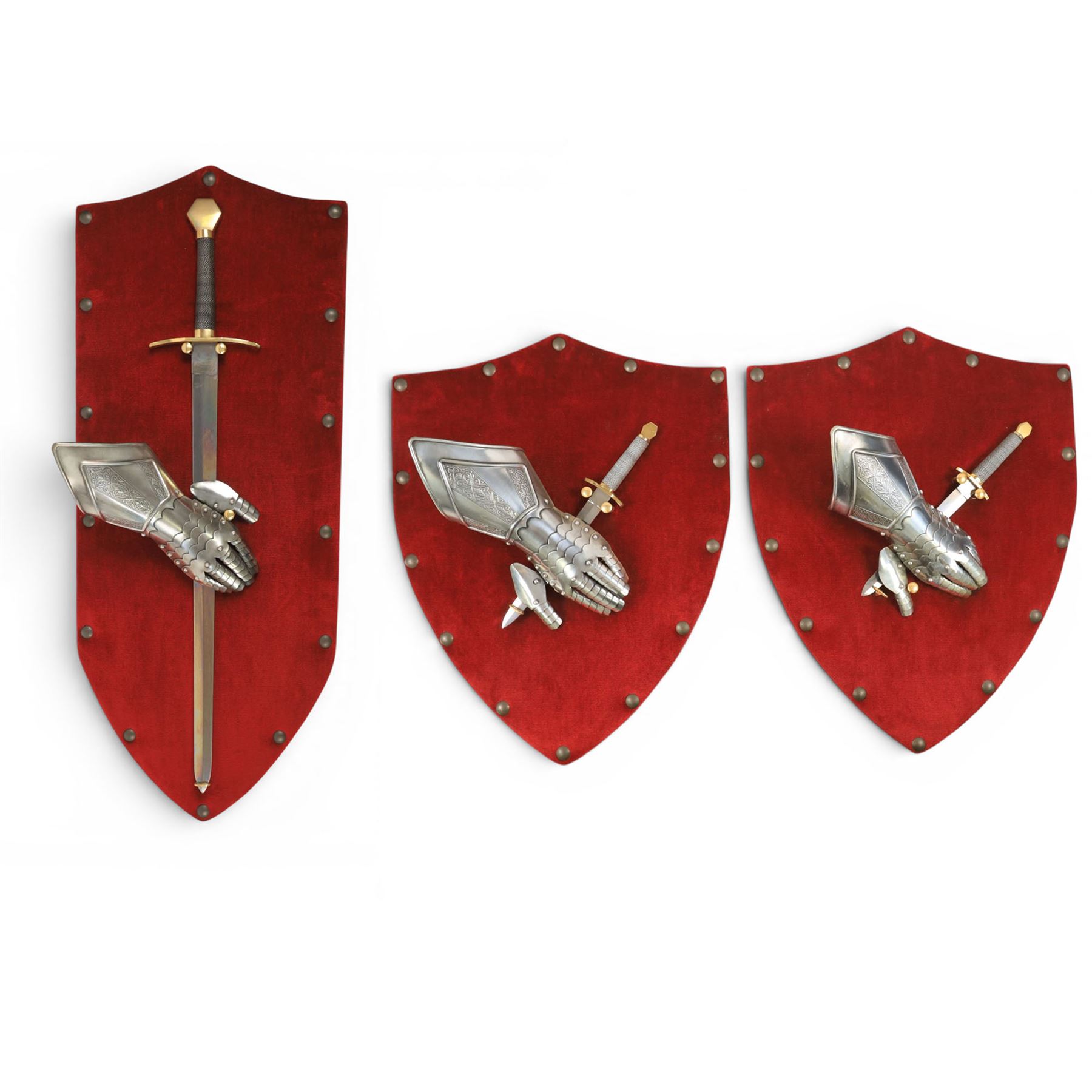 Three replica gauntlets, each housed upon a red wall shield, two with daggers, the third with a sword, largest H102cm