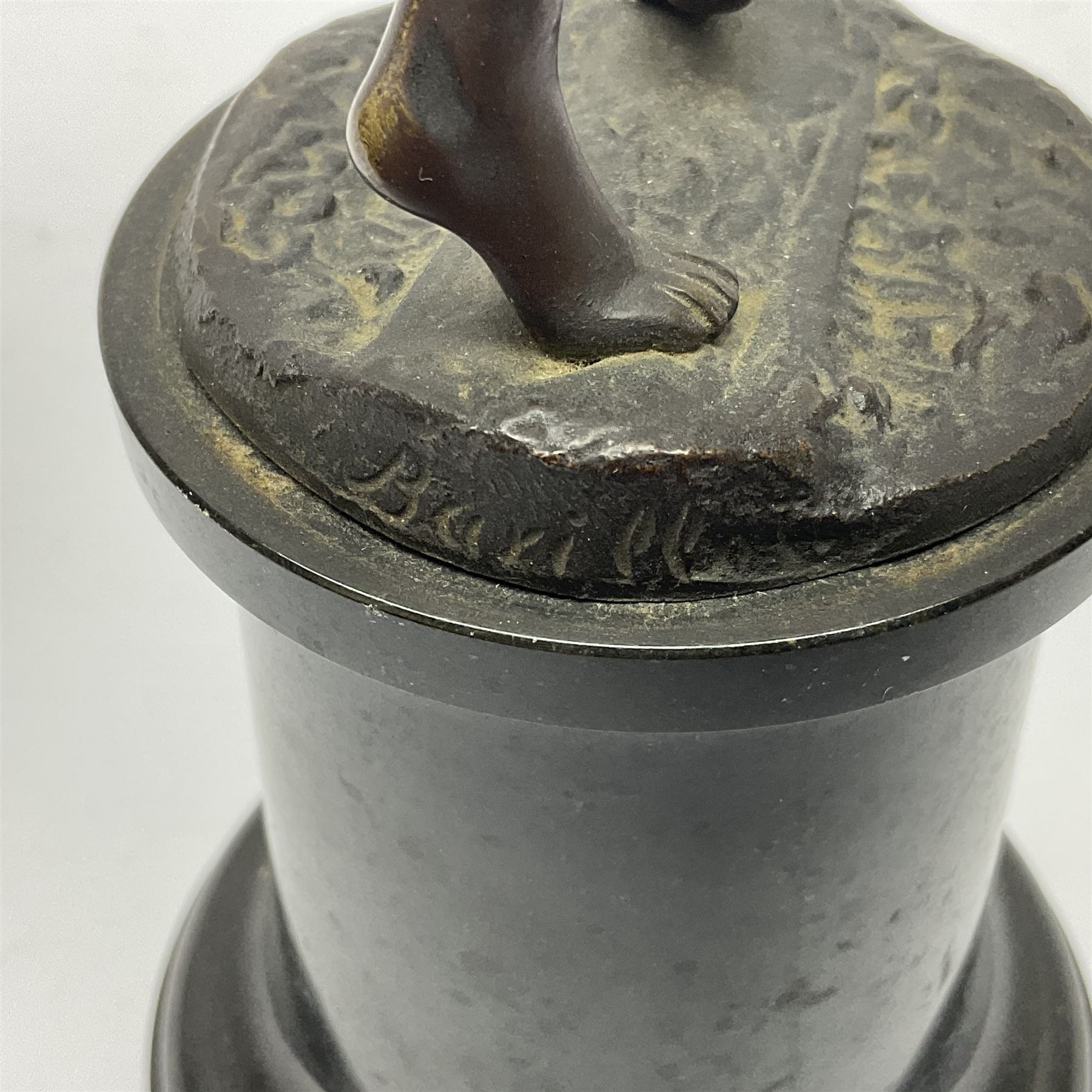 Bronze figure modelled as a nude woman with one arm raised a crescent moon upon her forehead, raised upon a circular stepped plinth, H36cm