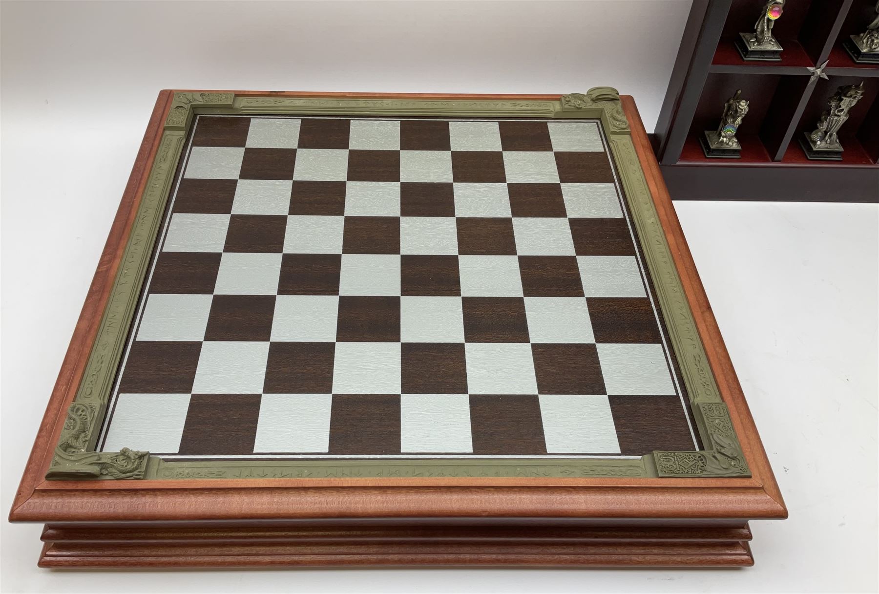 Danbury Mint 'The Fantasy of the Crystal' chess set consisting of mythical pewter chess pieces within a wooden case with chess board lid, together with 16 additional chess pieces in a wooden display case.