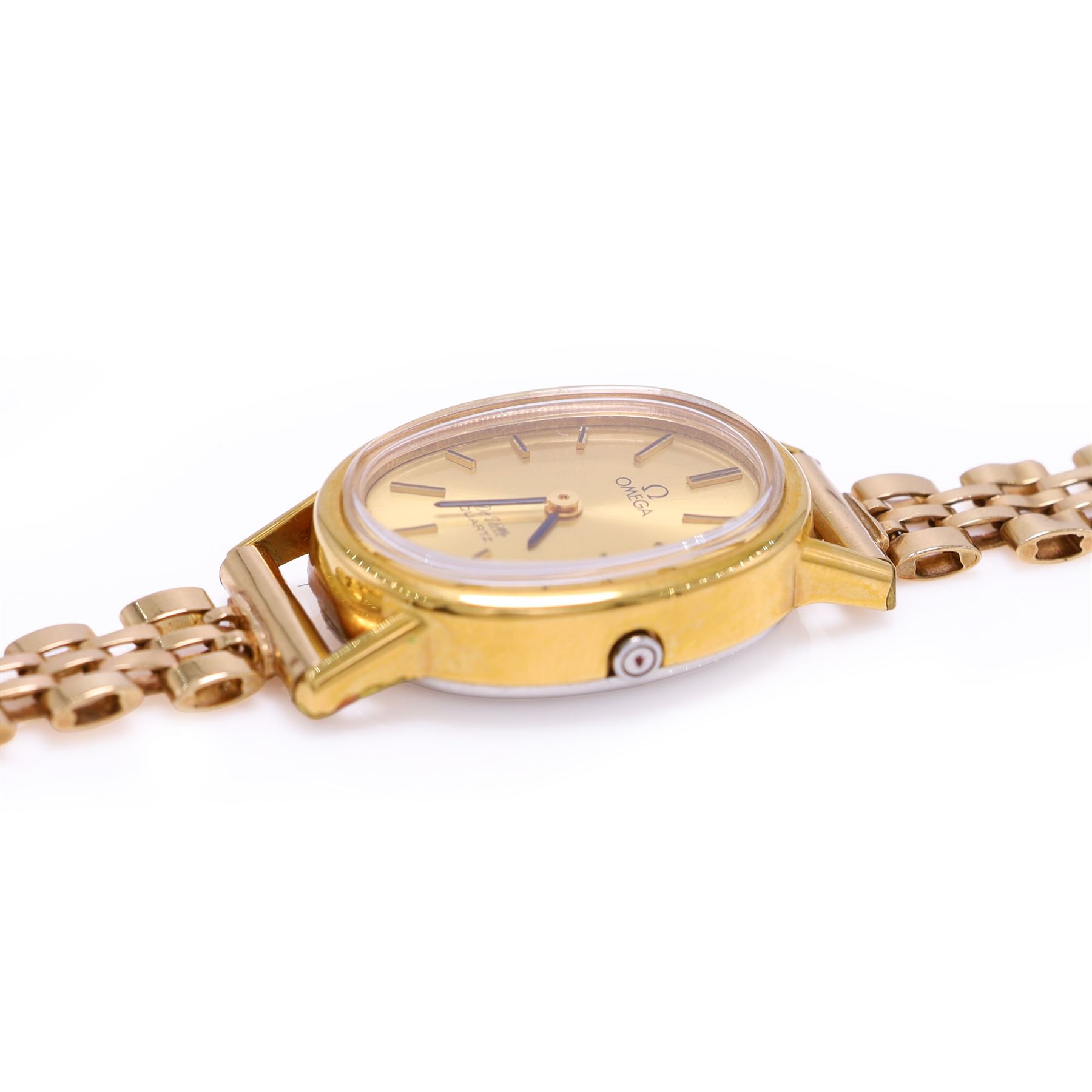 Omega ladies gold-plated quartz wristwatch, gilt dial with baton hour markers, on 9ct gold bracelet, Birmingham 1977, boxed with original leather strap