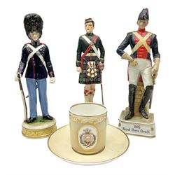 Three soldier figures comprising ‎Rudolf Kämmer Volkstedt figure of Den Kgl. Danske Livgarde, Goebel Argyll & Sutherland Highlander and 1805 Royal Horse Guards figure, together with T. Goode & Co Spode teacup and saucer decorated with the Prince of Wales feathers and the German motto 'Ich dien' teacup and saucer